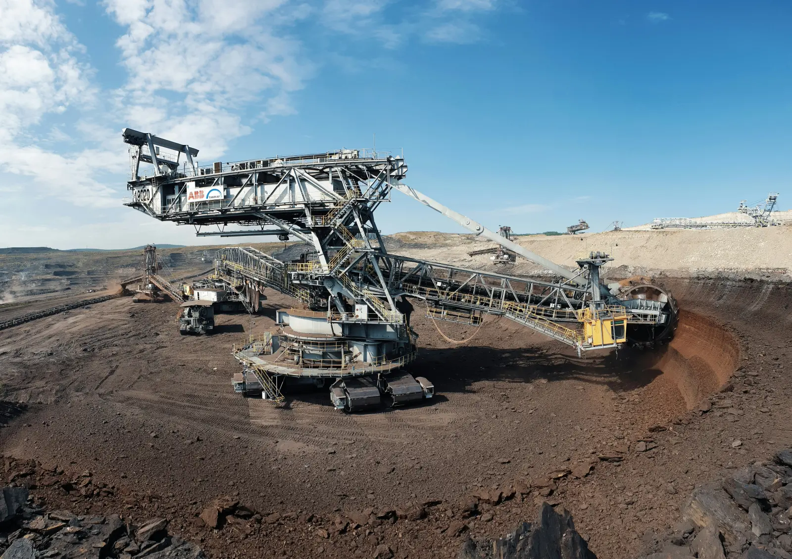 Heavy machinery working at an open-pit solid mineral mine